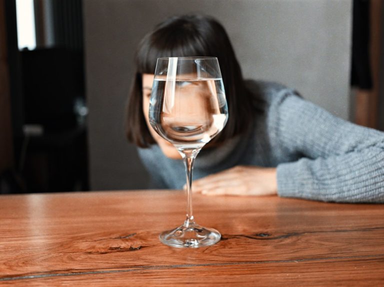 clear wine glass on brown wooden table