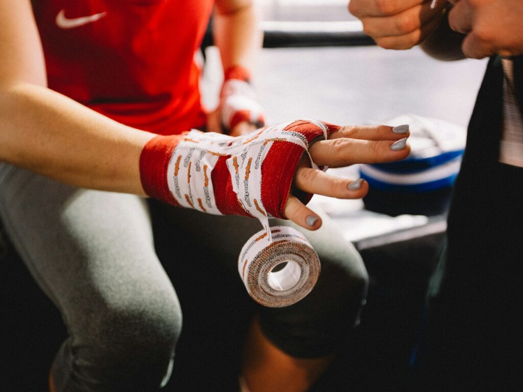 person wrapping bandage